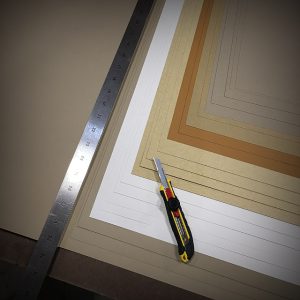 Hand cutting paper with a straight edge
